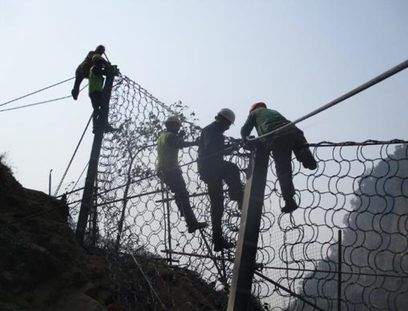GSI crew fixing ring-net panels to the Tamakoshi barrier